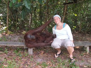 An orangutan reaching for Amanda's hat