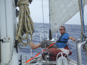 Gregg resting on sail bag on passage